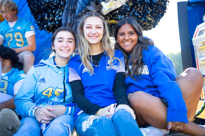 Students ride on a homecoming parade float